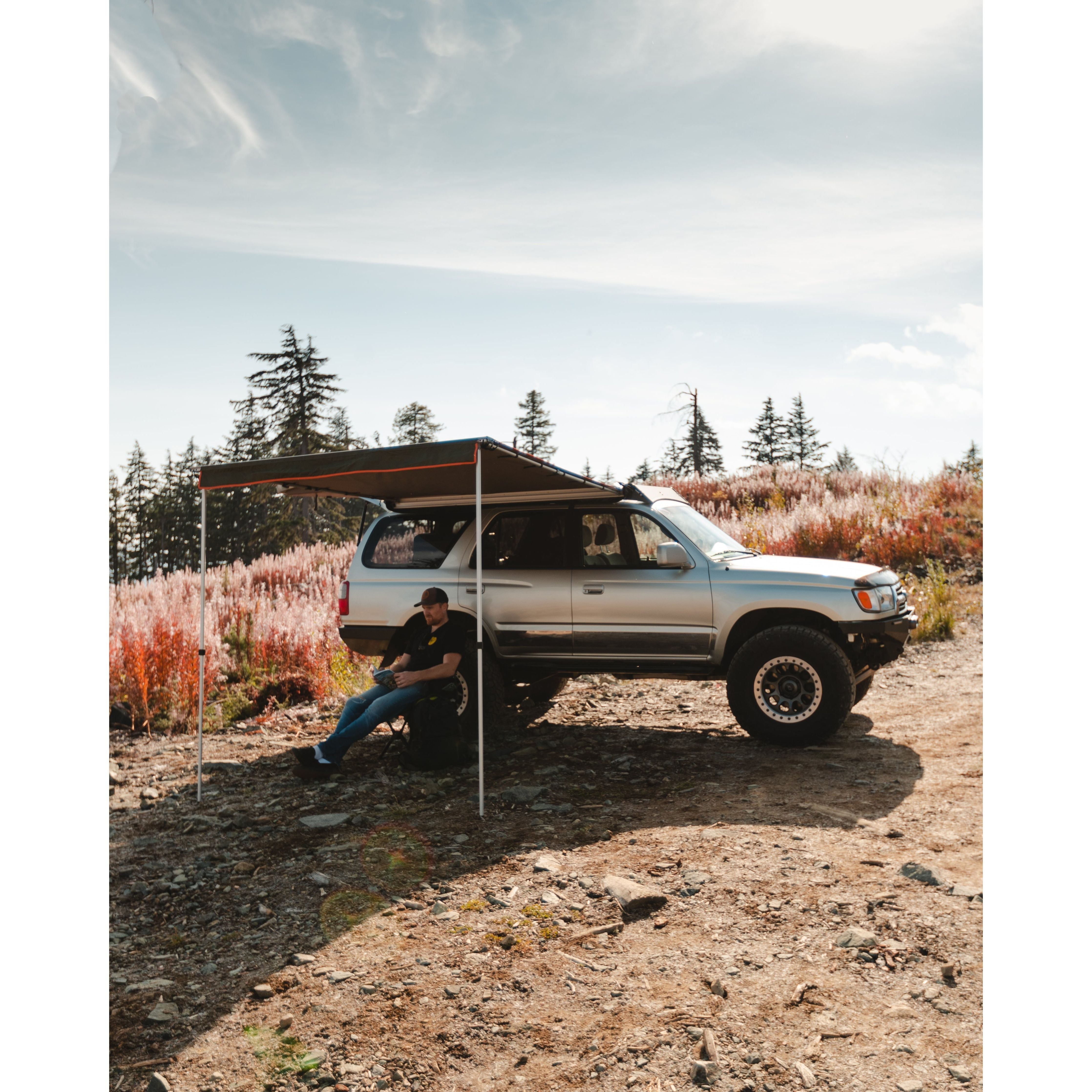 ROAM Adventure Co. Rooftop Awning provides shelter to someone enjoying the outdoors