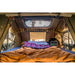 Interior of Vagabond XL Rooftop Tent with sheets, lights, and skylight